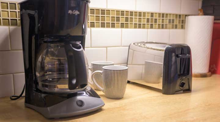 Coffee pot, toaster, and coffee mugs